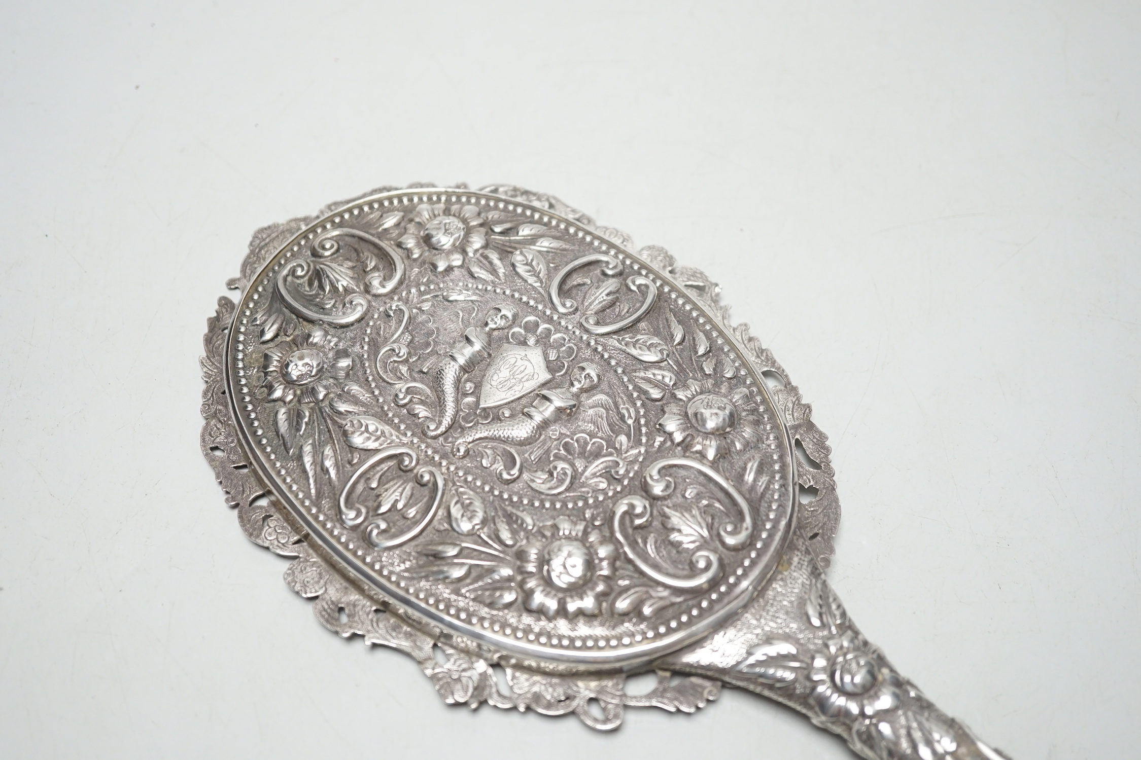 A late Victorian embossed silver hand mirror, Samuel Walton Smith, Birmingham, 1891, 27cm.